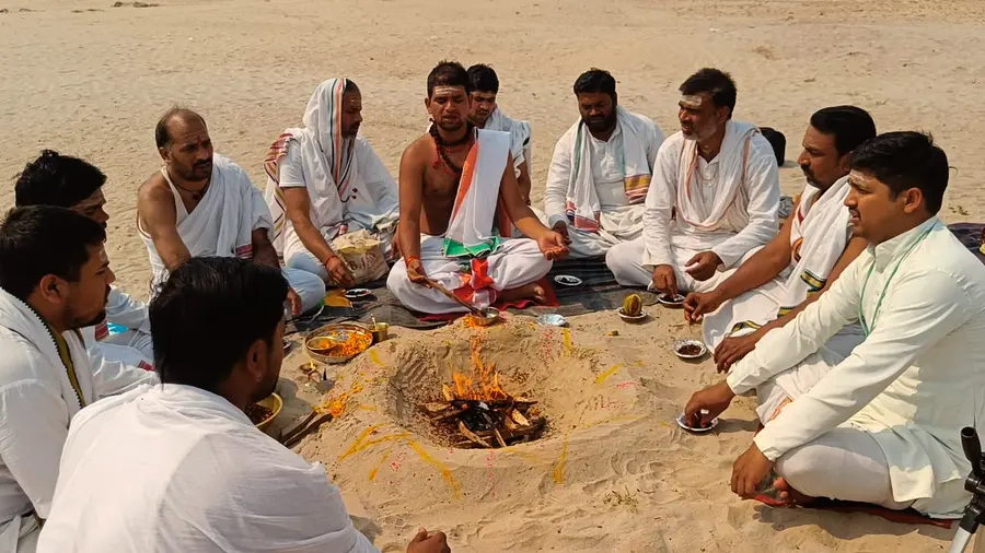 Priests gathered around the sacred fire during a Yagya