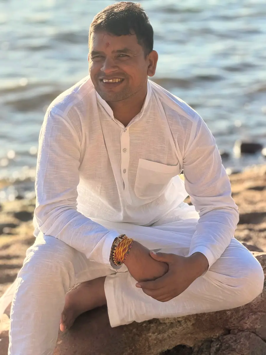 A priest from Lakshmi Narayan Ashram welcoming visitors