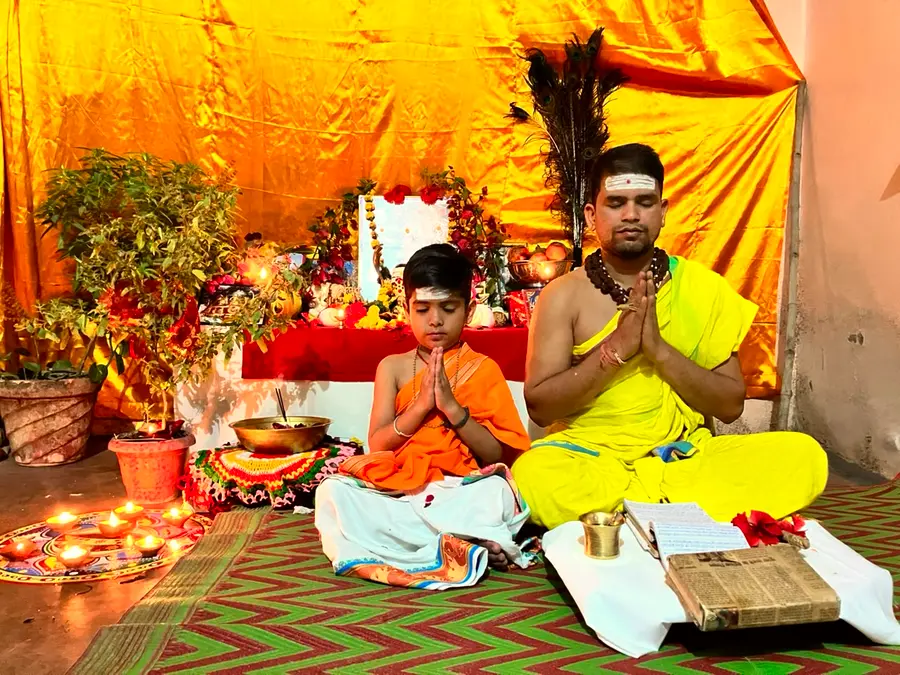 A priest guiding a young student, illustrating the Guru–Shishya relationship