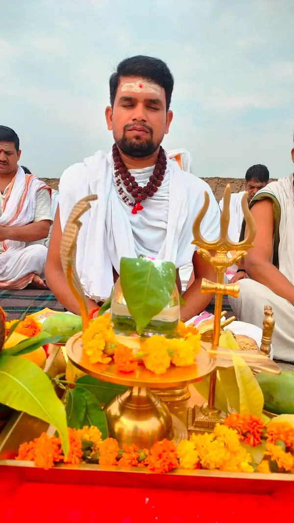 A priest performing a ritual offering, illustrating Karma in action