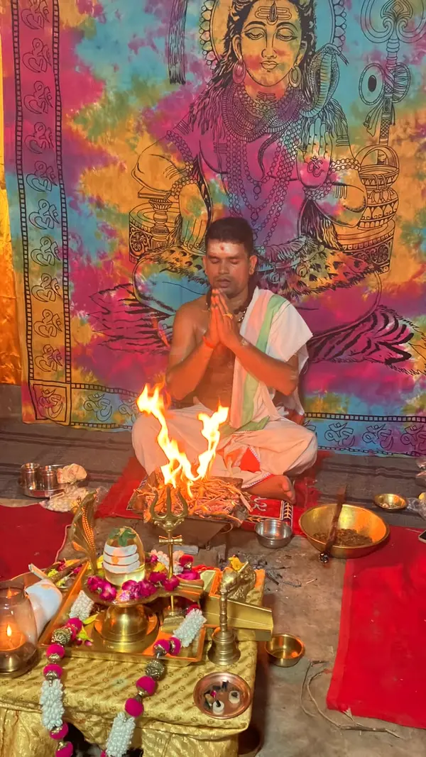 A priest seated in prayer, reciting Vedic mantras